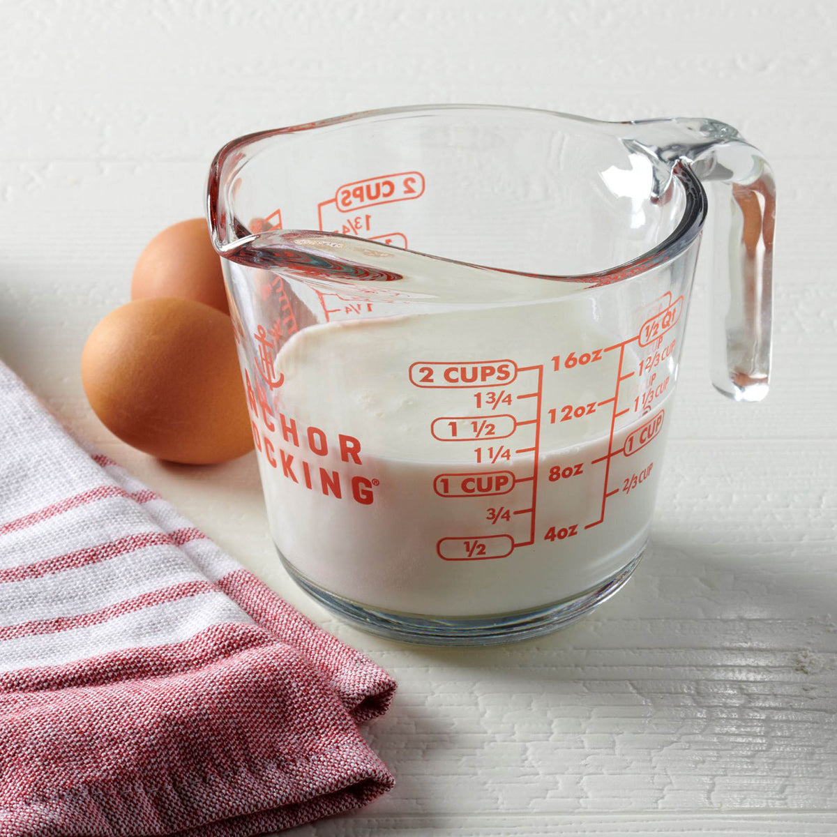Anchor Hocking glass measuring cup with clear measurement markings and a sturdy handle for precise liquid measurement.