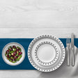 White CORELLE City Block dinnerware set with plates and bowls arranged on a table, showcasing durable ceramic design.