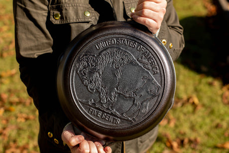 Lodge Classic buffalo cast iron skillet, 26 cm diameter, showing a seasoned cooking surface with sturdy handle and black finish.