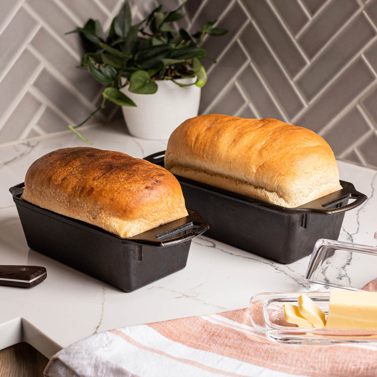 Lodge classic black bread proofing basket with oval shape and woven rattan design for baking artisan bread.