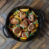 Lodge 26cm black classic baking pan with a sturdy handle and non-stick surface for versatile baking.