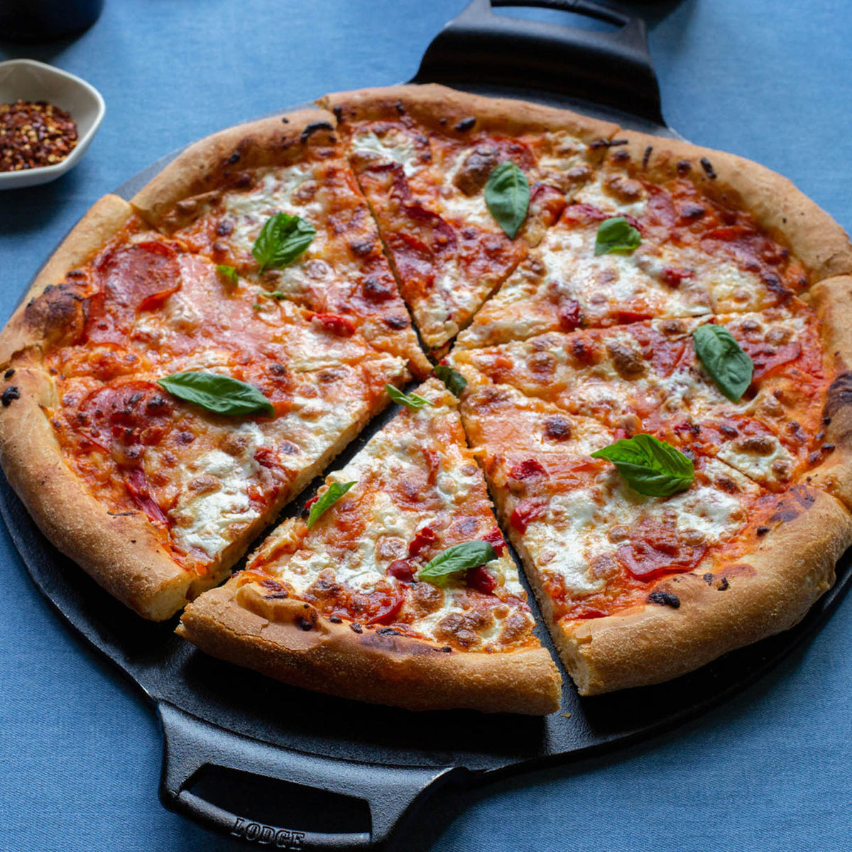 Lodge classic black 31.8 cm pizza baking pan with a sturdy rectangular shape and non-stick coating for even baking.