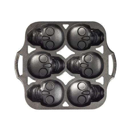 Lodge classic black cake pan with six skull-shaped molds, ideal for creative baking and themed cake designs.