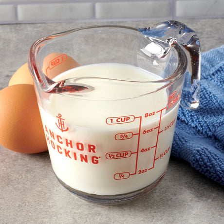Anchor Hocking measuring cup with clear glass body and measurement markings for accurate liquid measurement.