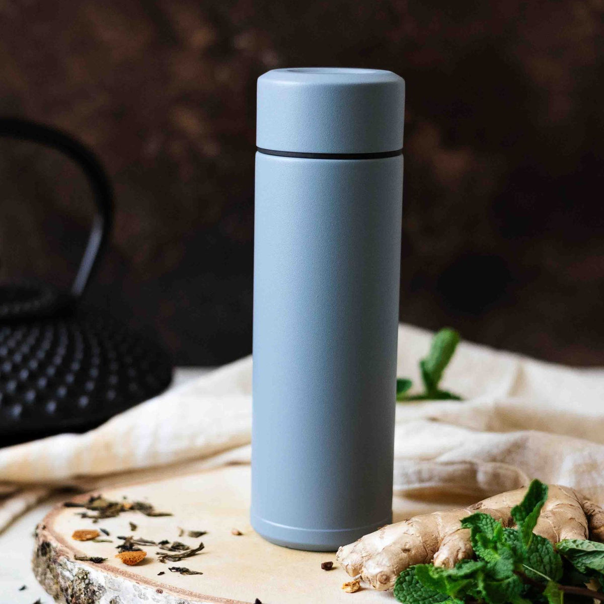 Blue KYOCERA Slim Mug insulated bottle showing sleek design and secure lid for hot or cold beverages.