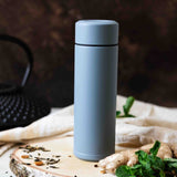 Blue KYOCERA Slim Mug insulated bottle showing sleek design and secure lid for hot or cold beverages.