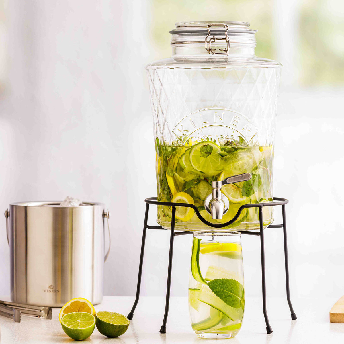 KILNER Diamond drink dispenser with clear glass body and metal spigot for serving beverages at gatherings.